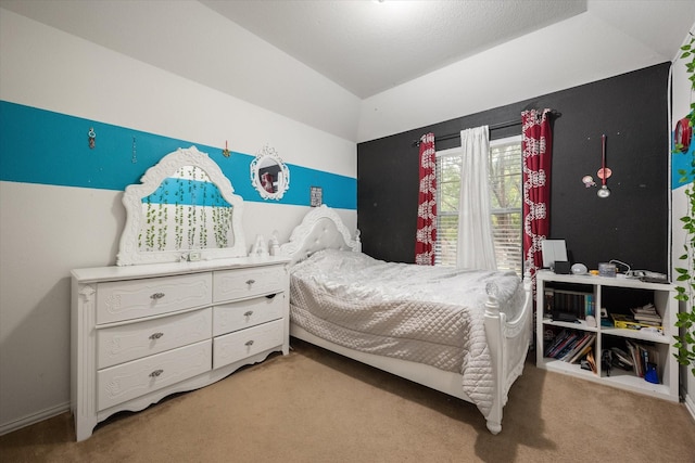 bedroom with a textured ceiling, carpet floors, and lofted ceiling