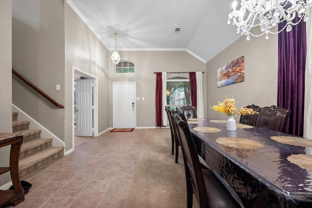 dining room with light carpet, ornamental molding, lofted ceiling, and a notable chandelier