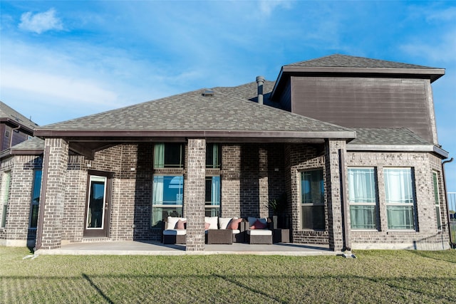 rear view of property featuring a patio area, an outdoor living space, and a yard