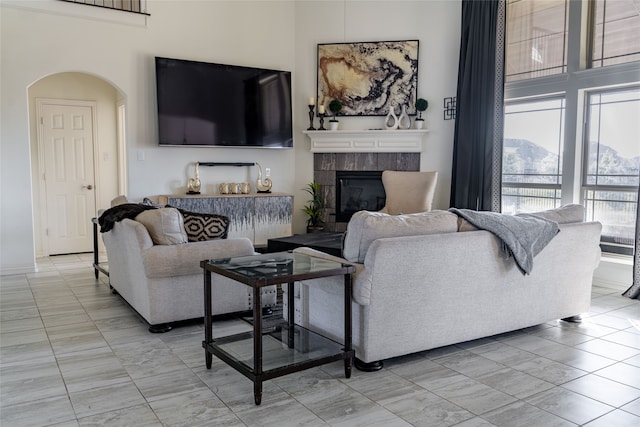 living room featuring a tiled fireplace