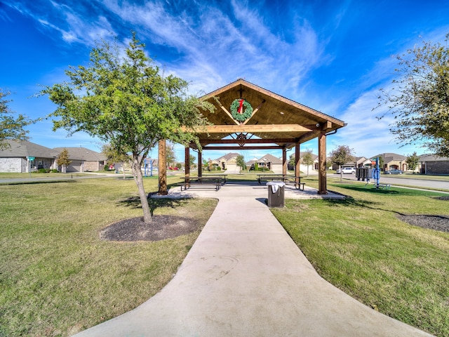 view of property's community with a lawn and a gazebo