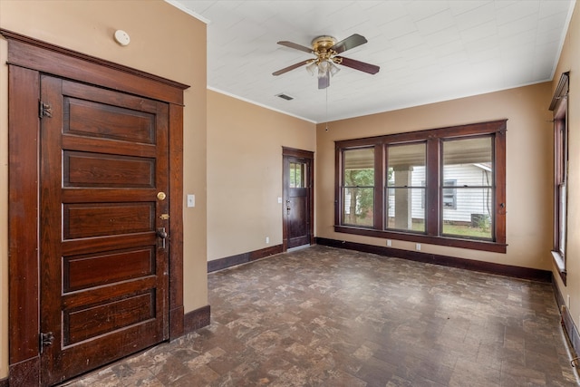 foyer with ceiling fan and crown molding