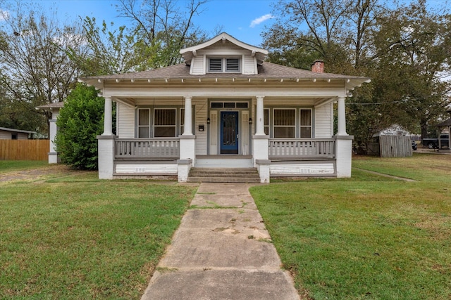 bungalow-style home featuring a front lawn and covered porch