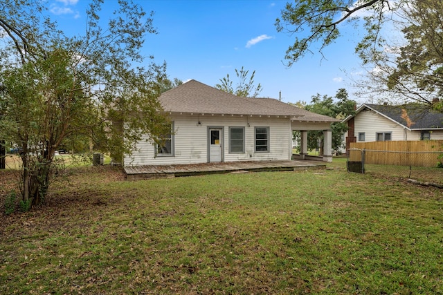 back of house featuring a lawn and a patio area