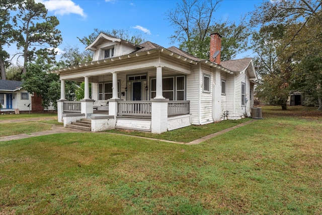 bungalow-style home featuring a front yard, a porch, and central AC