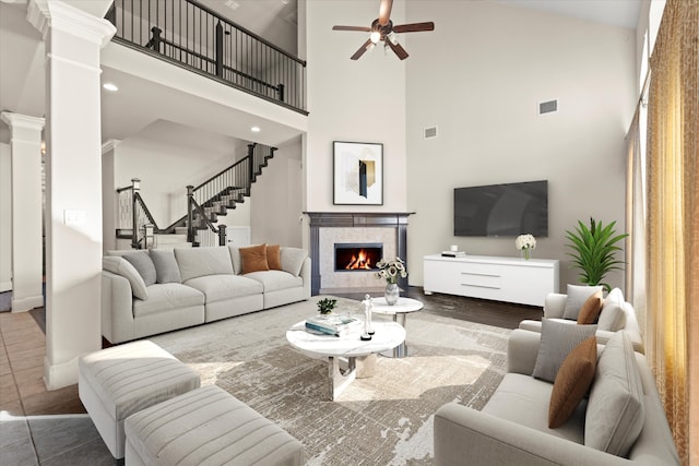 living room with ornate columns, ceiling fan, dark hardwood / wood-style flooring, and high vaulted ceiling