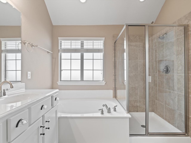 bathroom featuring vanity, shower with separate bathtub, and vaulted ceiling