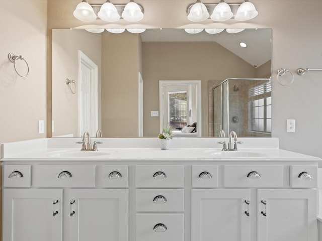 bathroom with vanity, walk in shower, and lofted ceiling