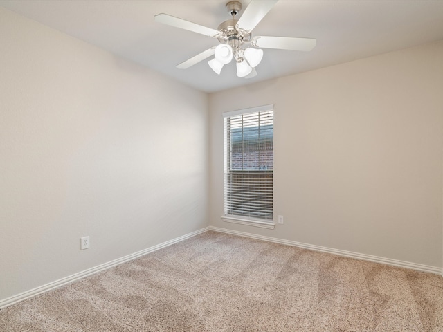 spare room featuring carpet and ceiling fan