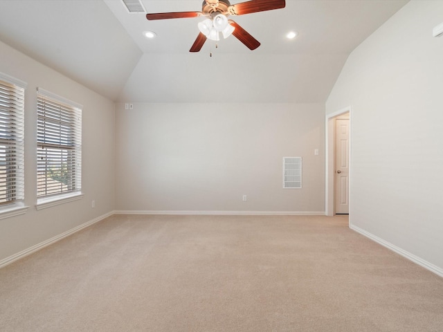 carpeted empty room featuring ceiling fan and vaulted ceiling