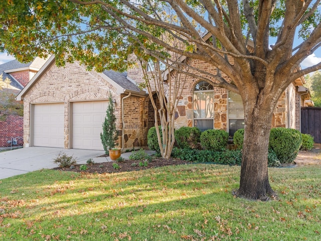 view of front of house with a front yard and a garage