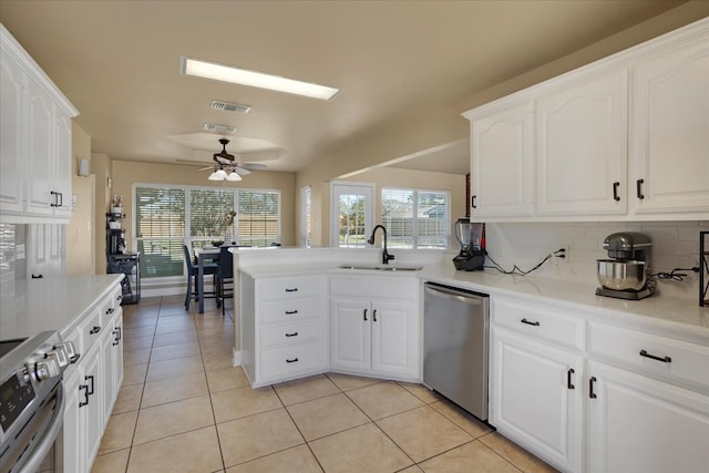 kitchen featuring backsplash, white cabinetry, sink, and stainless steel appliances