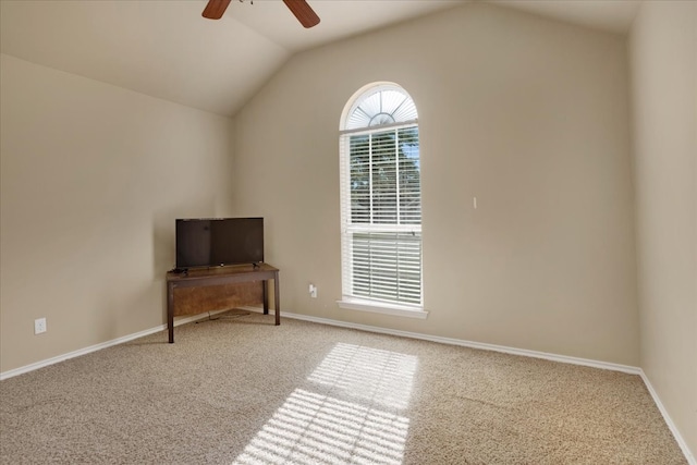 unfurnished room with ceiling fan, light colored carpet, and lofted ceiling