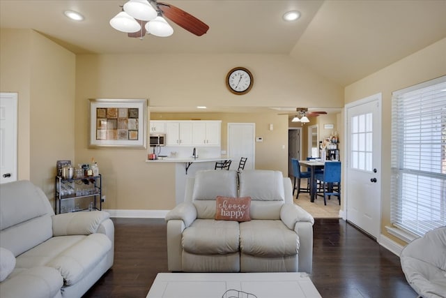 living room with dark hardwood / wood-style floors, vaulted ceiling, ceiling fan, and sink