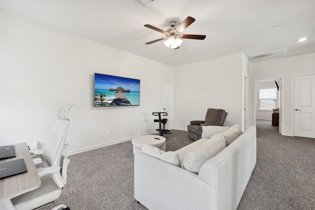 carpeted living room with ceiling fan