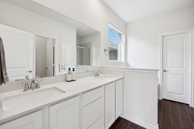 bathroom with vanity, hardwood / wood-style flooring, and a shower with shower door