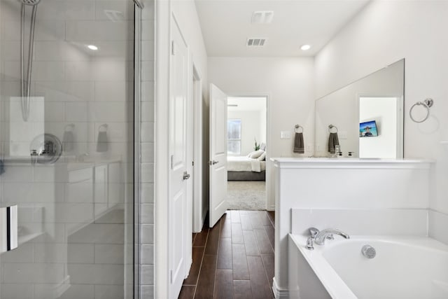 bathroom with plus walk in shower and hardwood / wood-style flooring