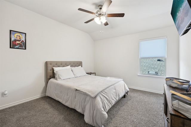 bedroom featuring dark colored carpet, vaulted ceiling, and ceiling fan