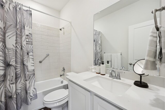 full bathroom featuring vanity, shower / tub combo with curtain, and toilet