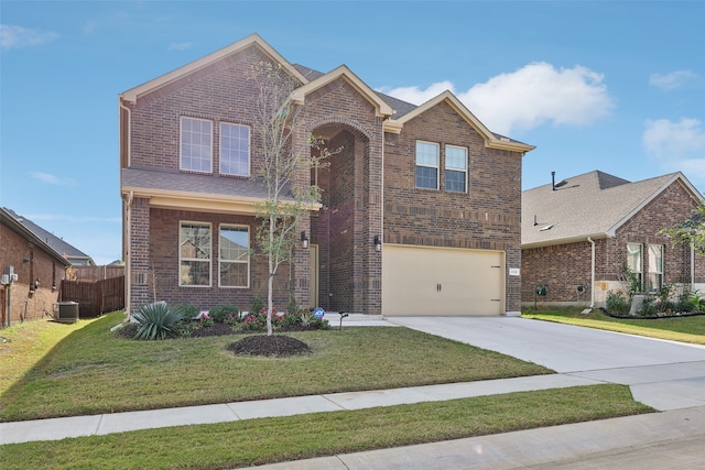 front facade featuring a front yard, central AC, and a garage