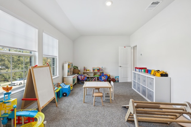 playroom with carpet floors and vaulted ceiling