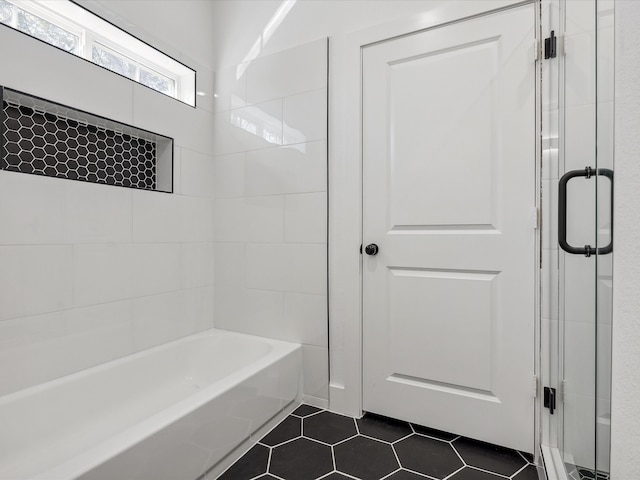 bathroom featuring tile patterned flooring and shower with separate bathtub