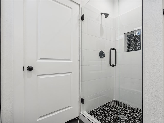 bathroom with a shower with door