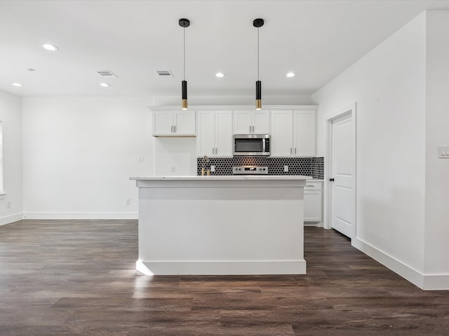 kitchen featuring pendant lighting, white cabinetry, an island with sink, and dark wood-type flooring