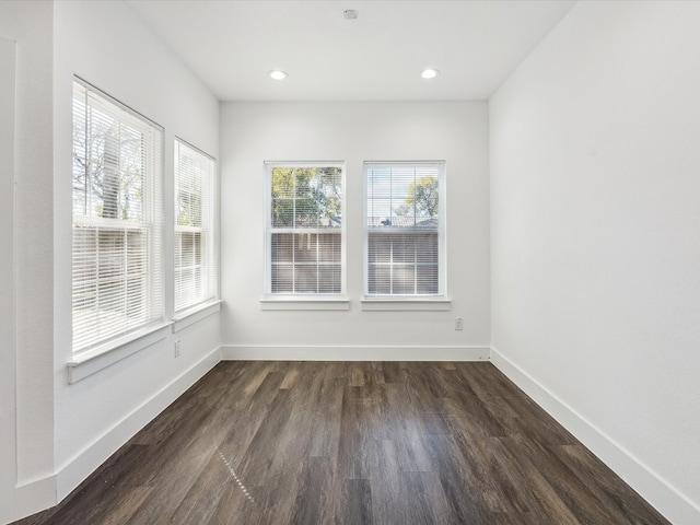 spare room with dark hardwood / wood-style flooring