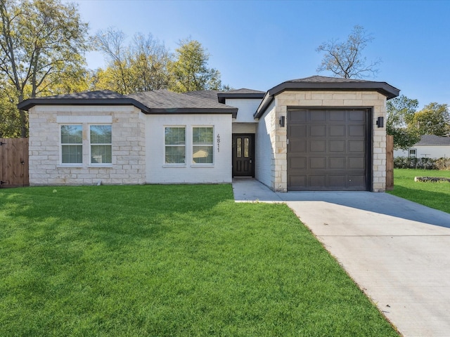 ranch-style home featuring a front yard and a garage