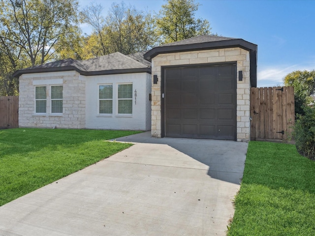 ranch-style house featuring a front lawn and a garage