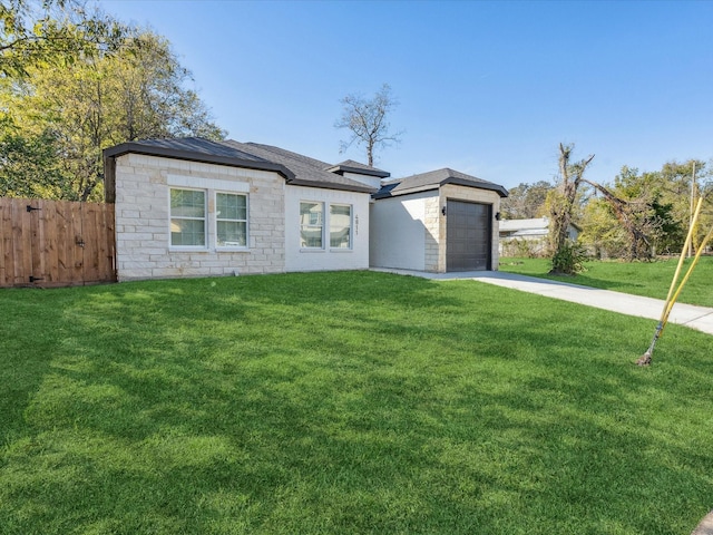 view of front of home with a garage and a front lawn