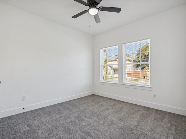 carpeted empty room featuring ceiling fan