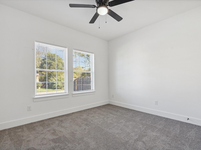 empty room with ceiling fan and carpet