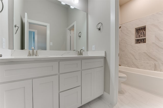 full bathroom with vanity, tiled shower / bath combo, and toilet