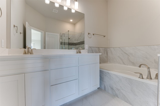 bathroom with vanity and independent shower and bath