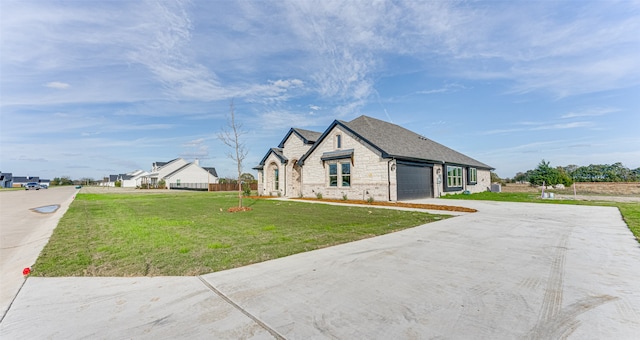 view of front of home featuring a garage and a front lawn