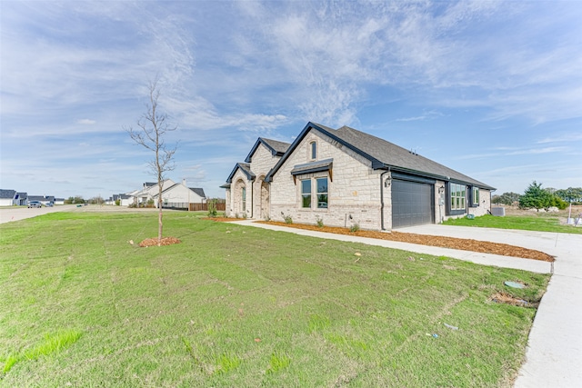 view of front of property with a garage and a front yard