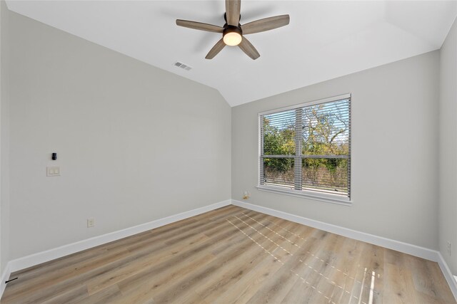 empty room featuring ceiling fan, light hardwood / wood-style flooring, and vaulted ceiling