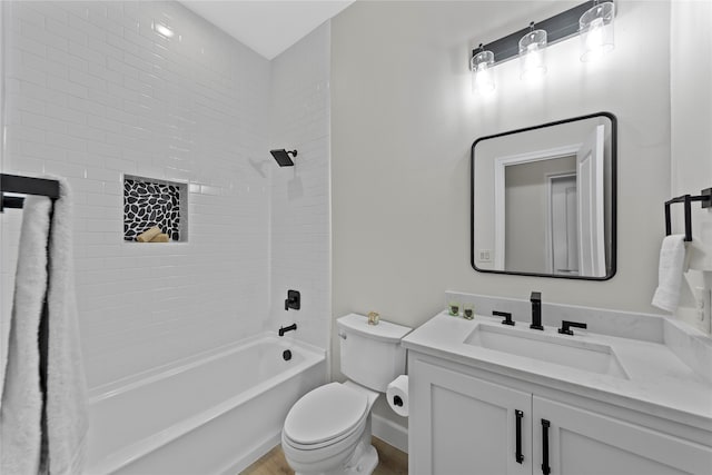 full bathroom with vanity, tiled shower / bath combo, and toilet