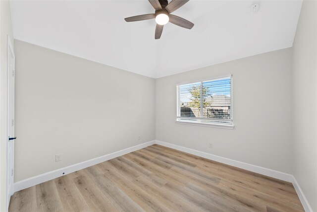 empty room featuring light hardwood / wood-style floors, vaulted ceiling, and ceiling fan