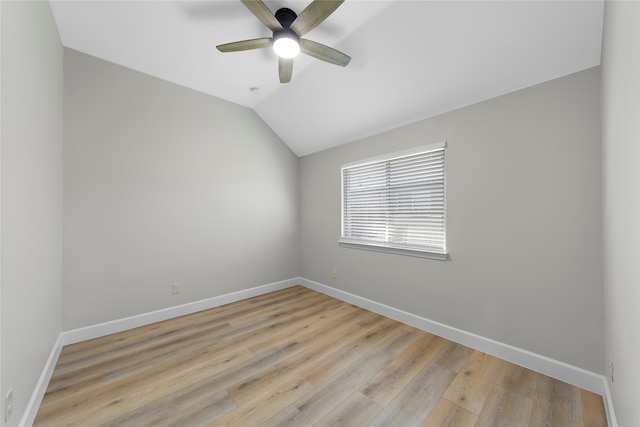 unfurnished room with ceiling fan, light hardwood / wood-style floors, and vaulted ceiling