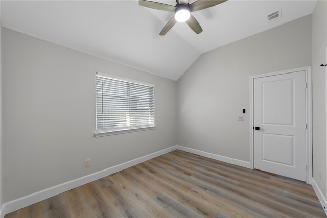 unfurnished room with ceiling fan, light hardwood / wood-style floors, and lofted ceiling