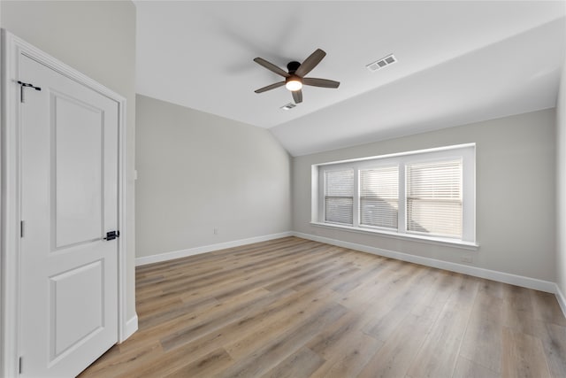 interior space featuring ceiling fan, light hardwood / wood-style floors, and vaulted ceiling