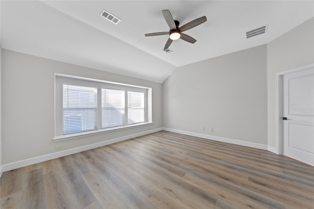 spare room featuring light hardwood / wood-style floors, ceiling fan, and lofted ceiling