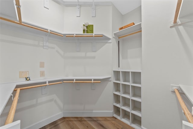 spare room with ceiling fan, light wood-type flooring, and lofted ceiling