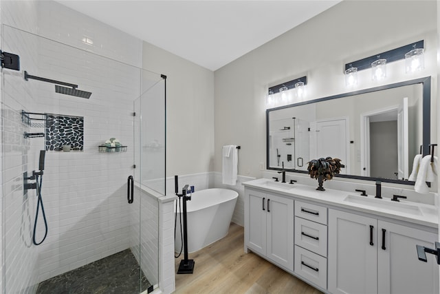 bathroom featuring hardwood / wood-style floors, vanity, separate shower and tub, and tile walls