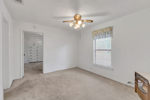 carpeted empty room featuring ceiling fan