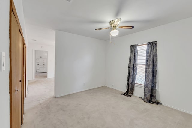 unfurnished room featuring ceiling fan and light carpet