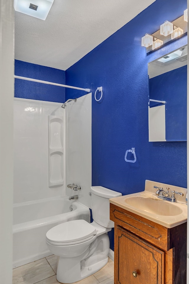 full bathroom featuring toilet, a textured ceiling, tile patterned flooring, shower / bathing tub combination, and vanity